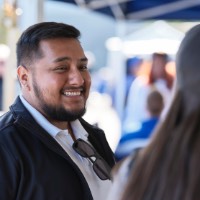 Man smiling at women